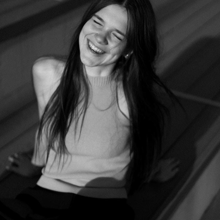 Priya Kapoor, Lead Design Curator at Spring Ember Leaf, reviewing corporate floral arrangements